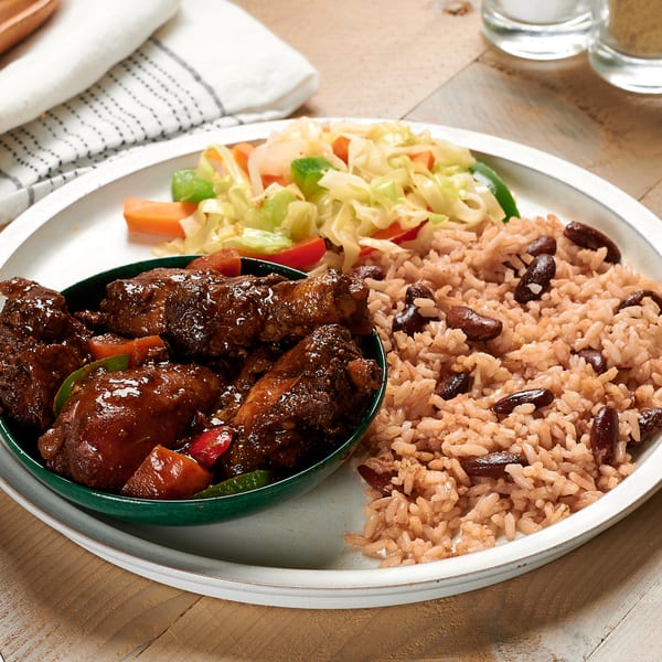 Negril Jamaican Restaurant's brown stew chicken with rice and peas, and steamed cabbage.